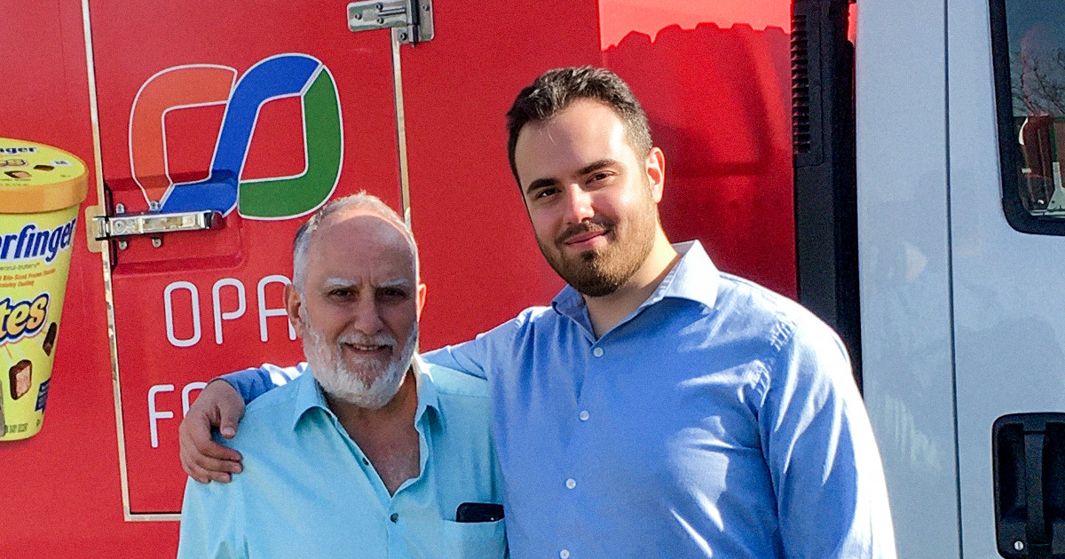 Photo of Max and Hani in front of their delivery truck